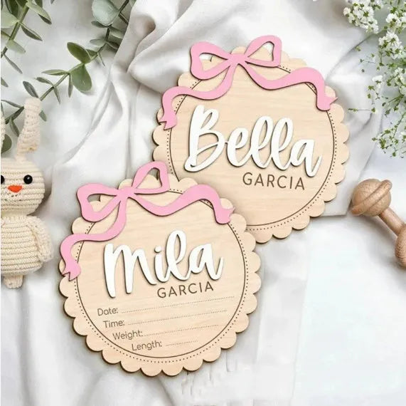Customised square wooden baby room ornament with a personal name, shown in two size options.