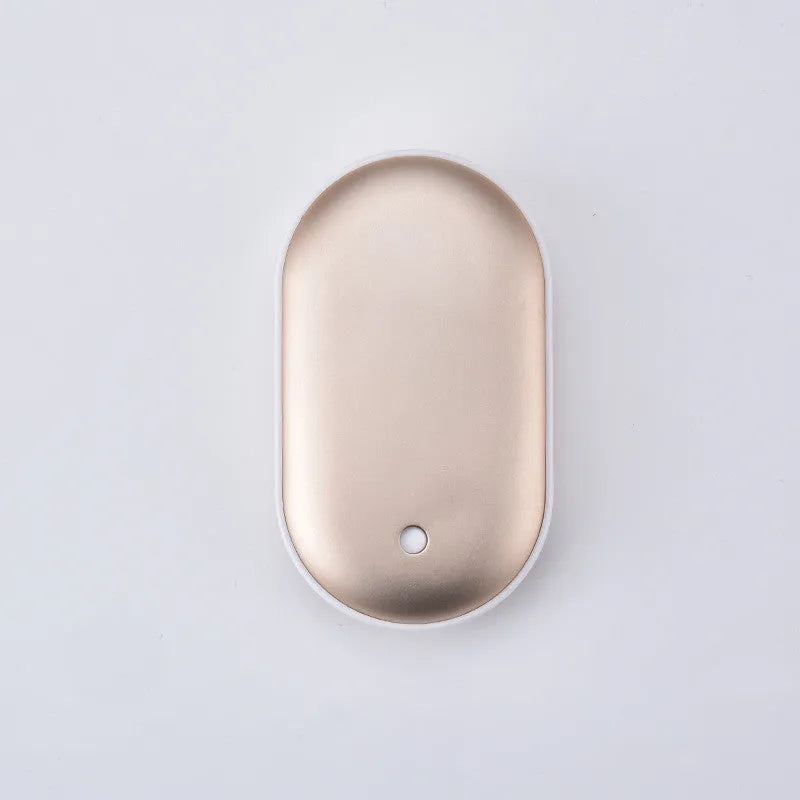Compact rose gold USB rechargeable hand warmer and power bank with digital display, shown next to its charging cable.