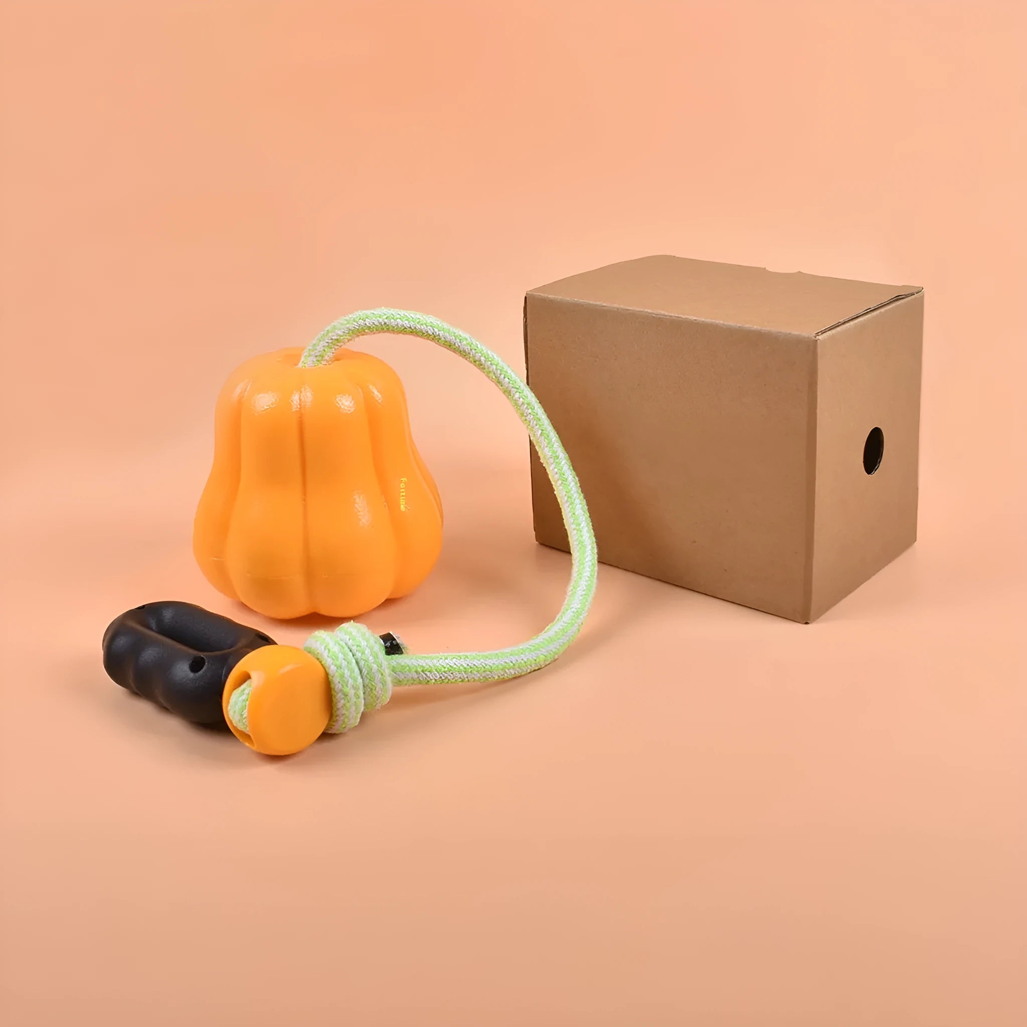 Orange plastic bite molar dog ball with rope attachment for outdoor fetch and chewing