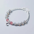 Adjustable natural moonstone bracelet with crescent moon charm on a wrist, showing extension chain.