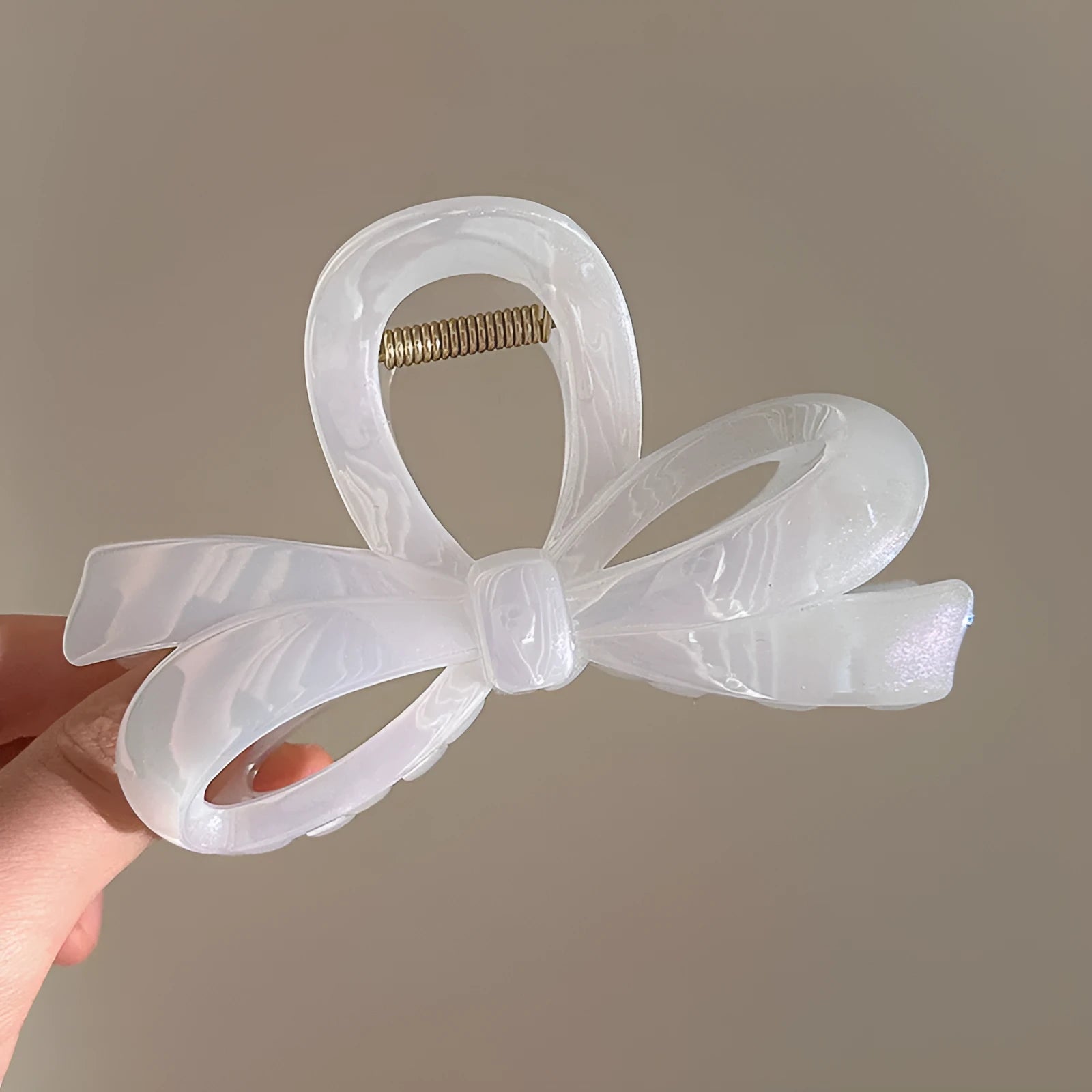 Women's ice bowknot resin hair clip with sweet bow design in blue, pink, and white colour options