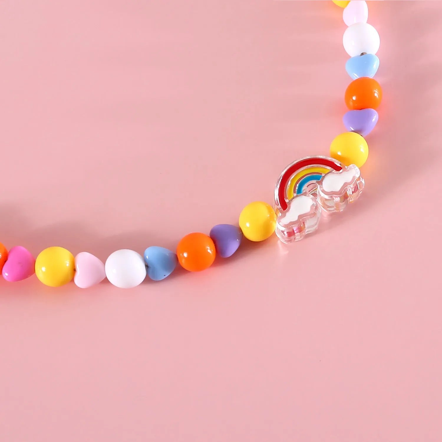 Colourful plastic bead cat necklace in small flower, rainbow, or peach design on adjustable cord.
