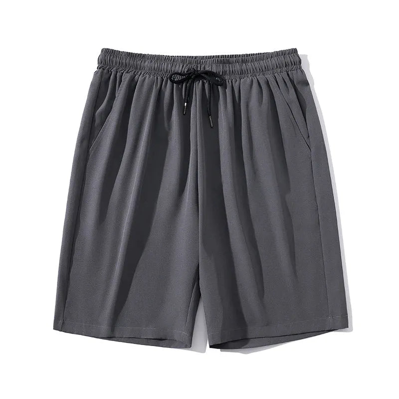 Man wearing grey cropped ice silk sports pants made from quick-dry nylon fabric.
