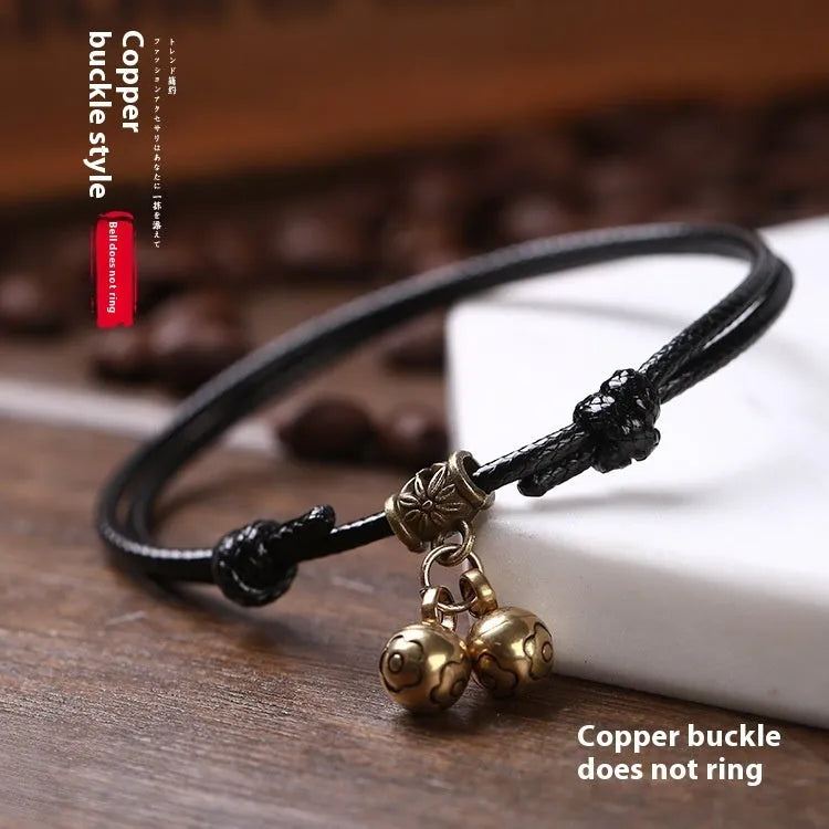 Adjustable nylon dog halter collar with brass bell shown in black rope colour fitting small dog