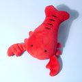 Red lobster-shaped squeaky plush dog toy with bite-resistant construction for small and medium breeds