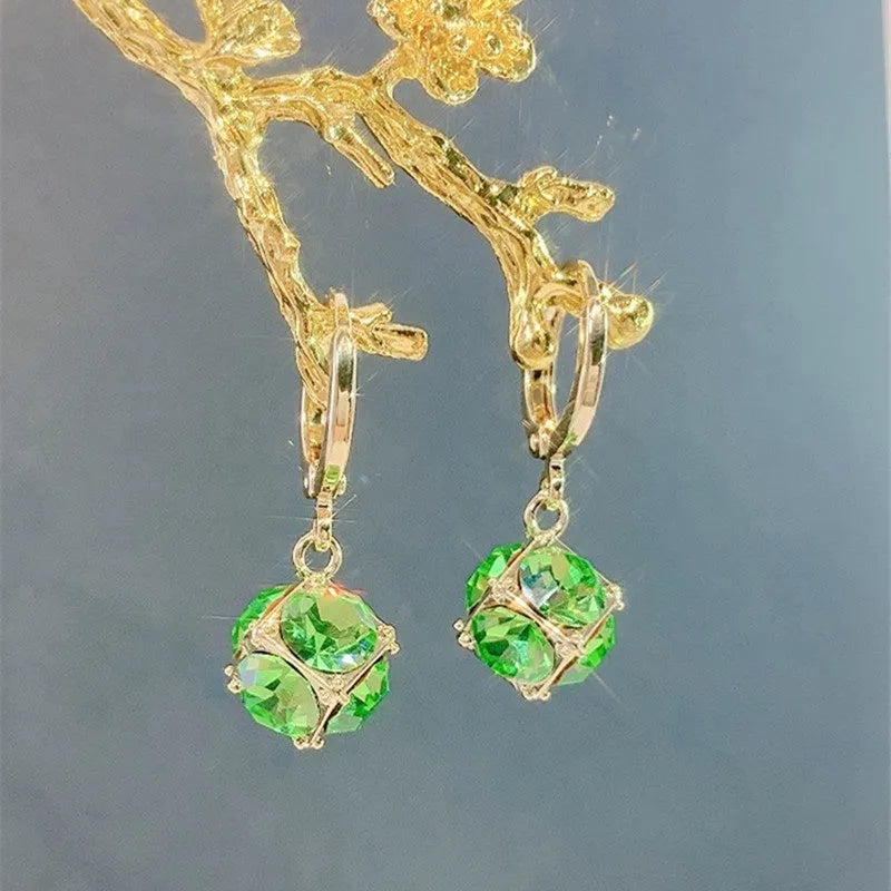 A pair of simple geometric rose-inspired earrings for women, made from electroplated copper, shown in one of the available colour types.