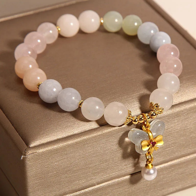 Women's colourful Morgan stone butterfly pendant crystal bracelet on wrist.