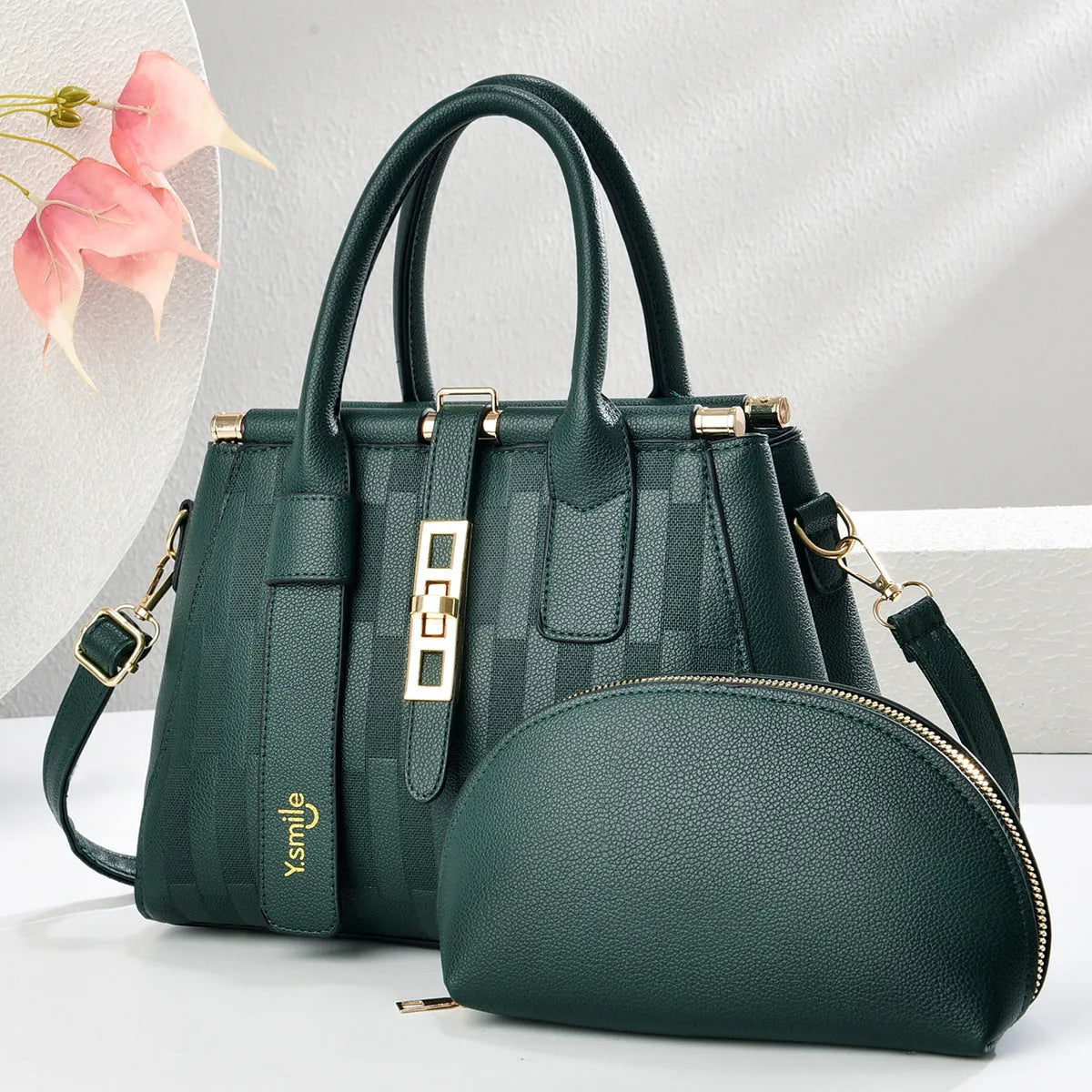Round black PU handbag with crossbody strap shown alongside light khaki and purplish red colour options