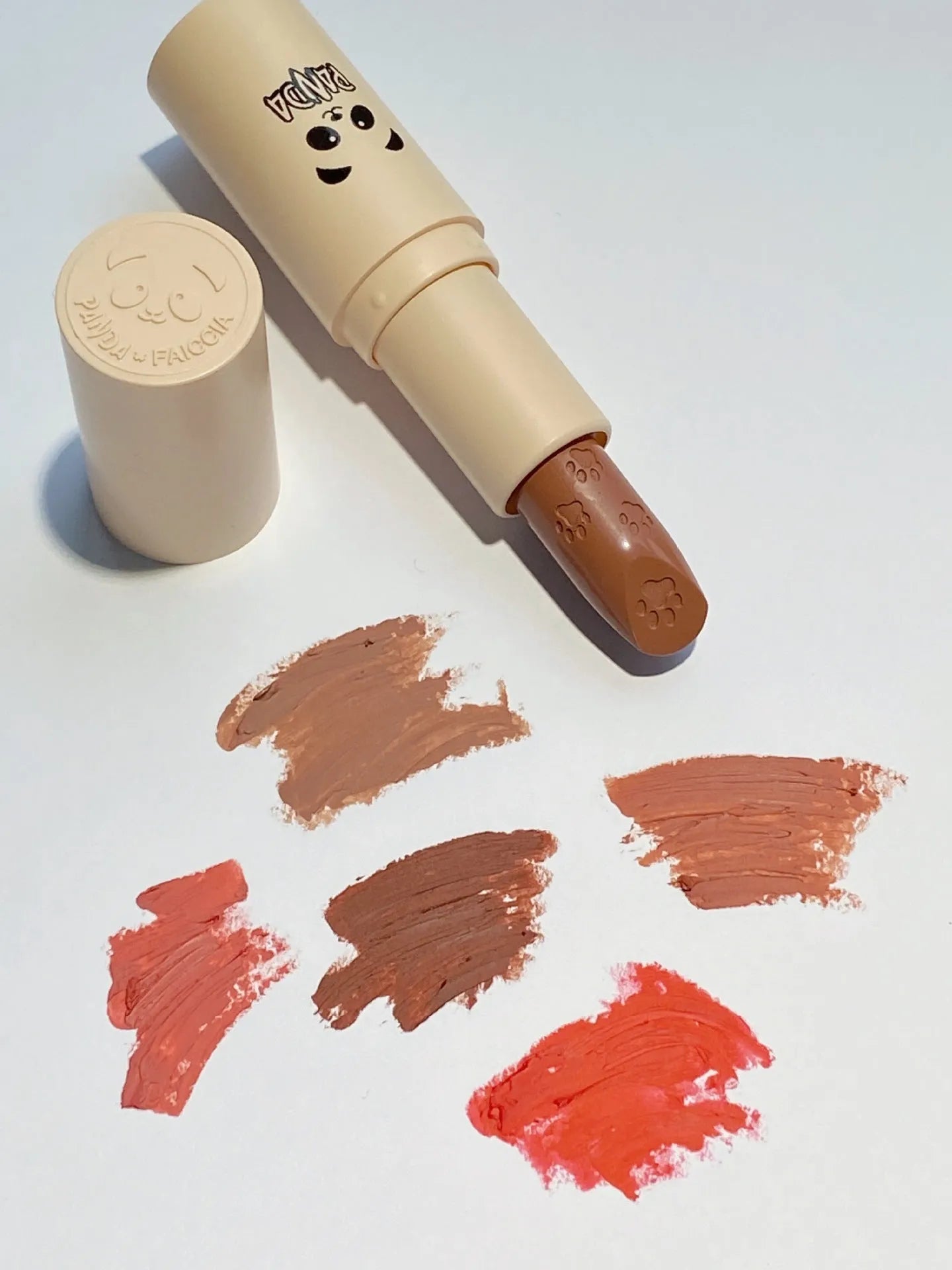 Little white tube matte velvet lipstick with five colour swatches Almond Cinnamon, Amber orange brown, Dirty Orange, Jujube Red Brown, White Peach Bean Paste