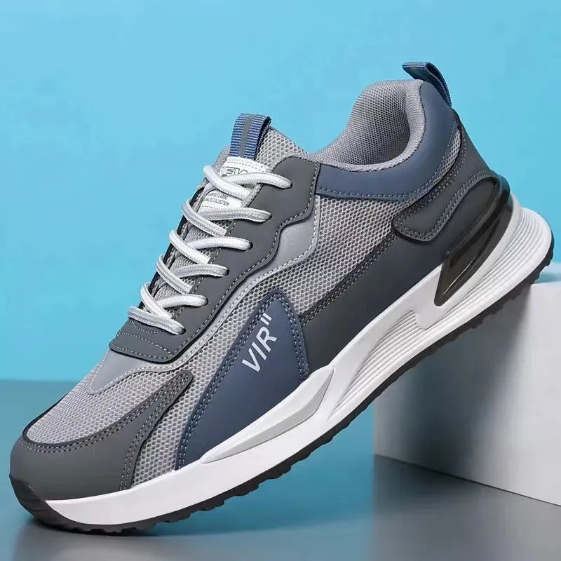 Men's colour block mesh sneakers in black, grey, and white with round toe and flat heel.