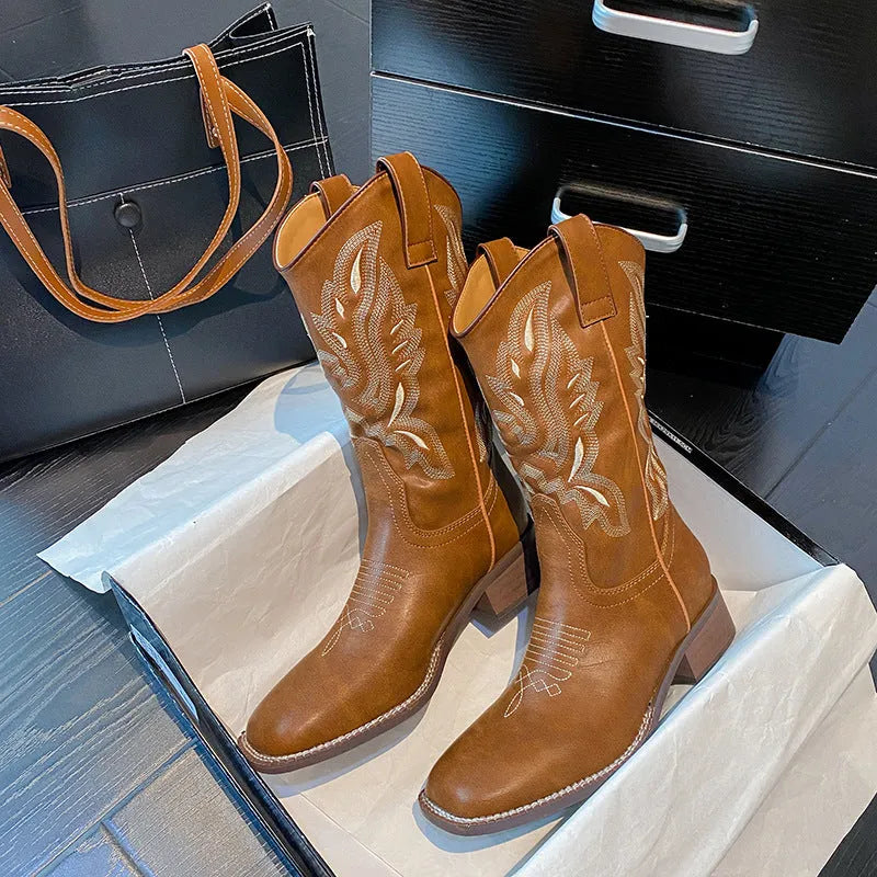 Brown women's Martin boots with embroidered toe cap and mid-calf height.