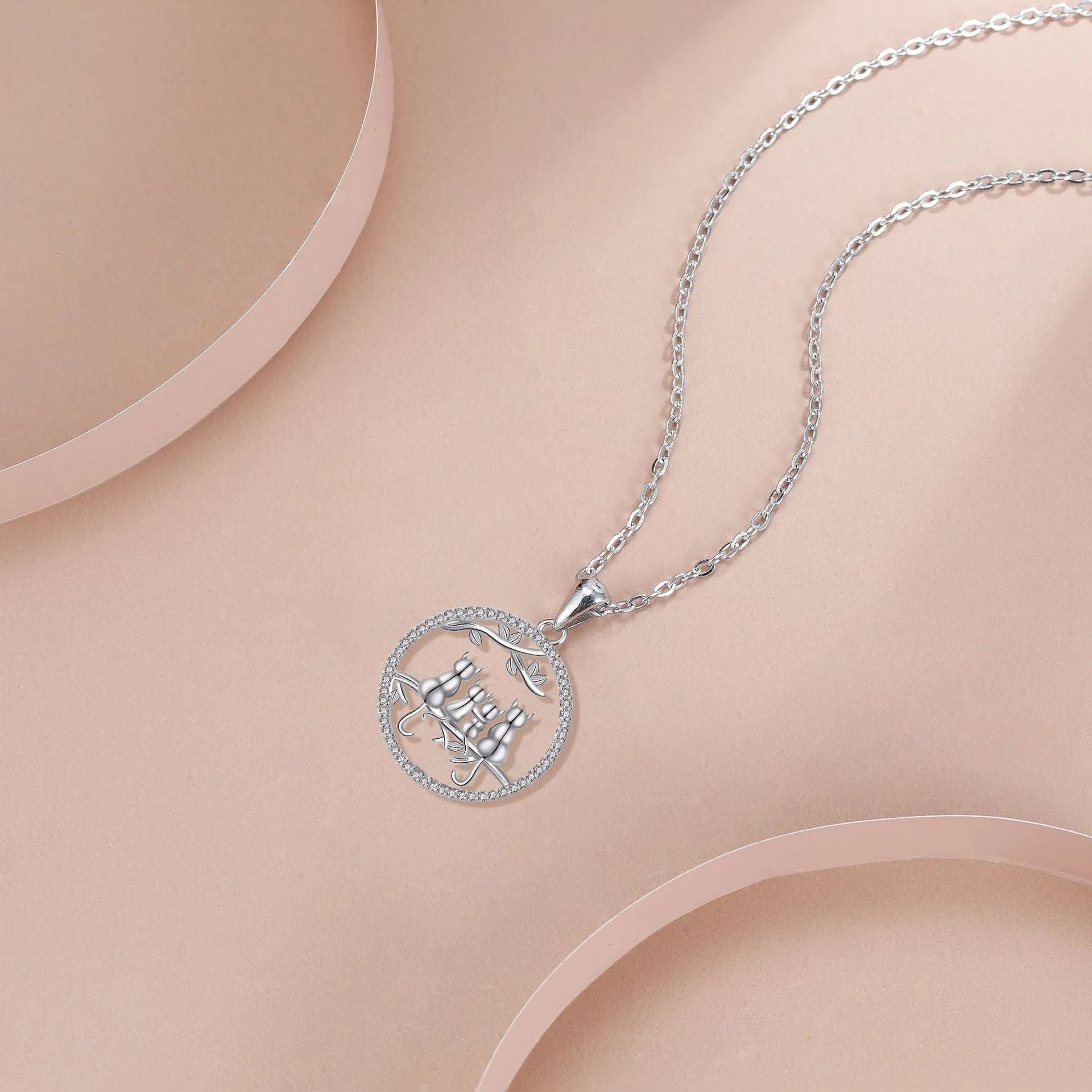 Copper necklace with a four-cat pendant on a textured cross chain, electroplated finish.