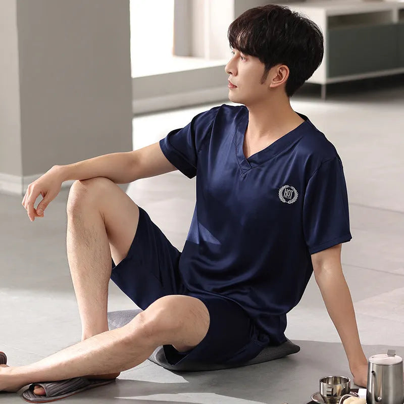 Man's light blue ice silk short-sleeve pajama shirt and loose matching shorts laid flat