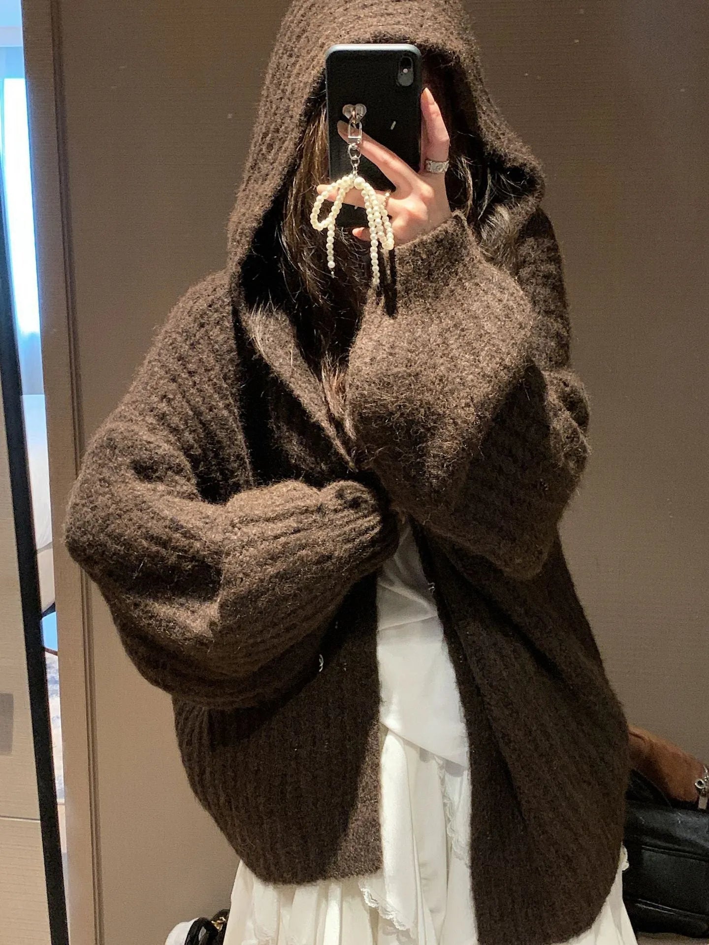 Women's dark grey loose-fit hooded cardigan sweater on a hanger