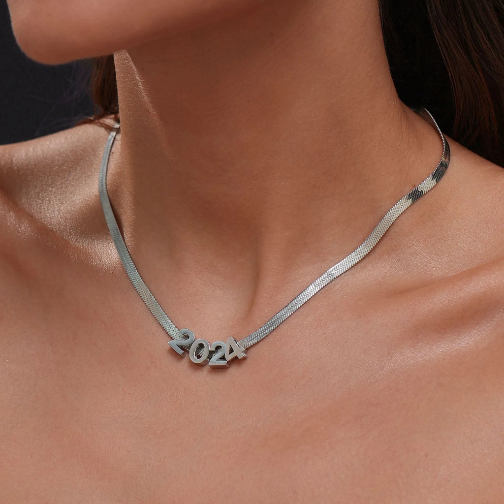 Gold and silver titanium steel initial number necklace with alphabet and number pendants on a 40.5cm chain.