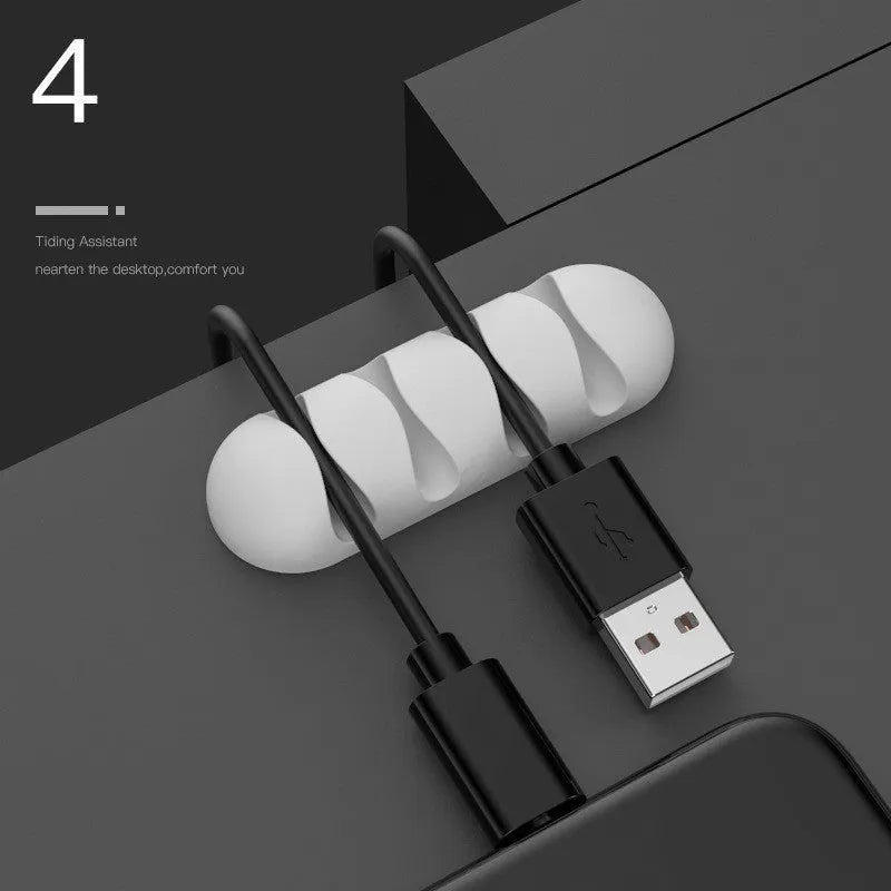 Smart cable holder with TPR flexible clips in black holding USB earphone and network cables on a desk