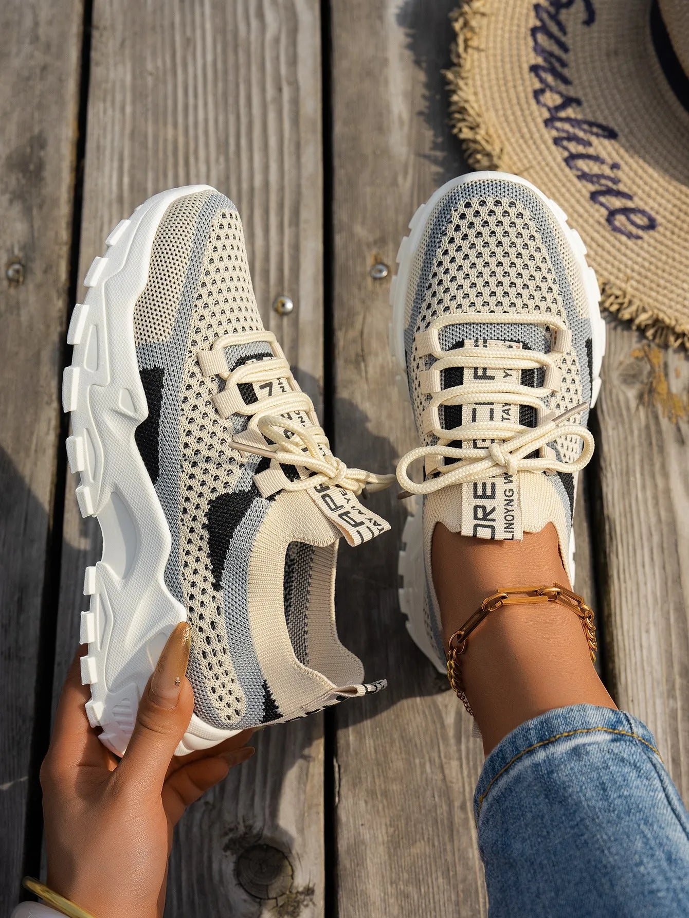 Women's lace-up Flyknit mesh sneakers in a grey colour combination with a round toe and flat rubber sole.