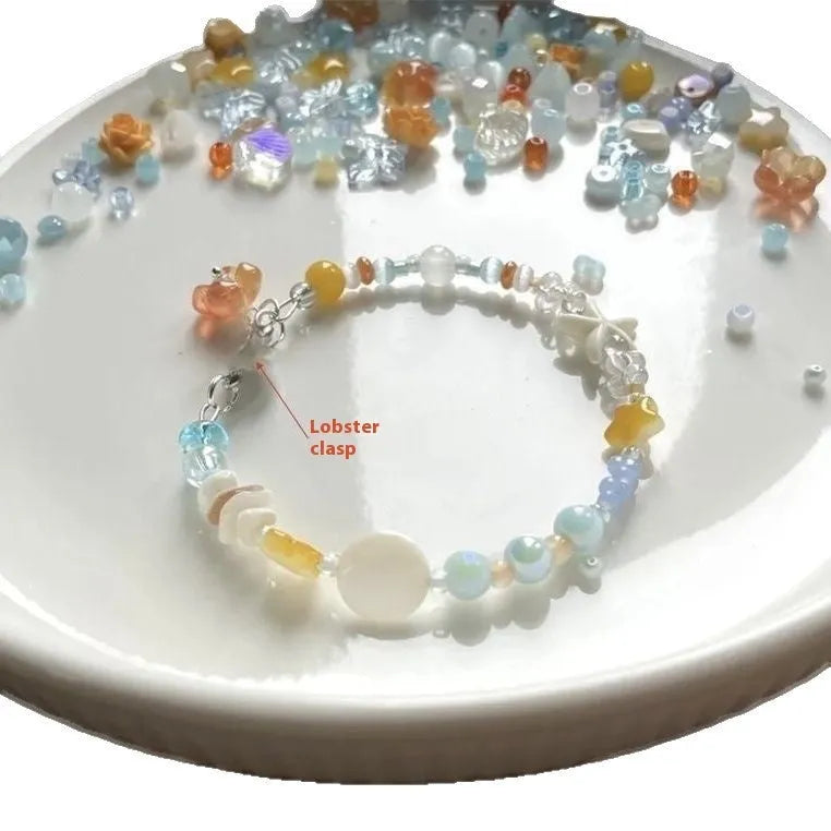 Orange and sea tone mixed material bracelet with diamond shapes and round elements