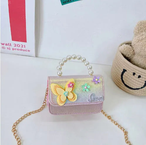 Children's small PU leather shoulder bag with letter print in rose red, showing zipper closure and multiple internal slots
