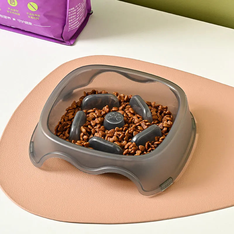 Blue plastic slow feeder dog bowl for anti-choking feeding on a plain surface.