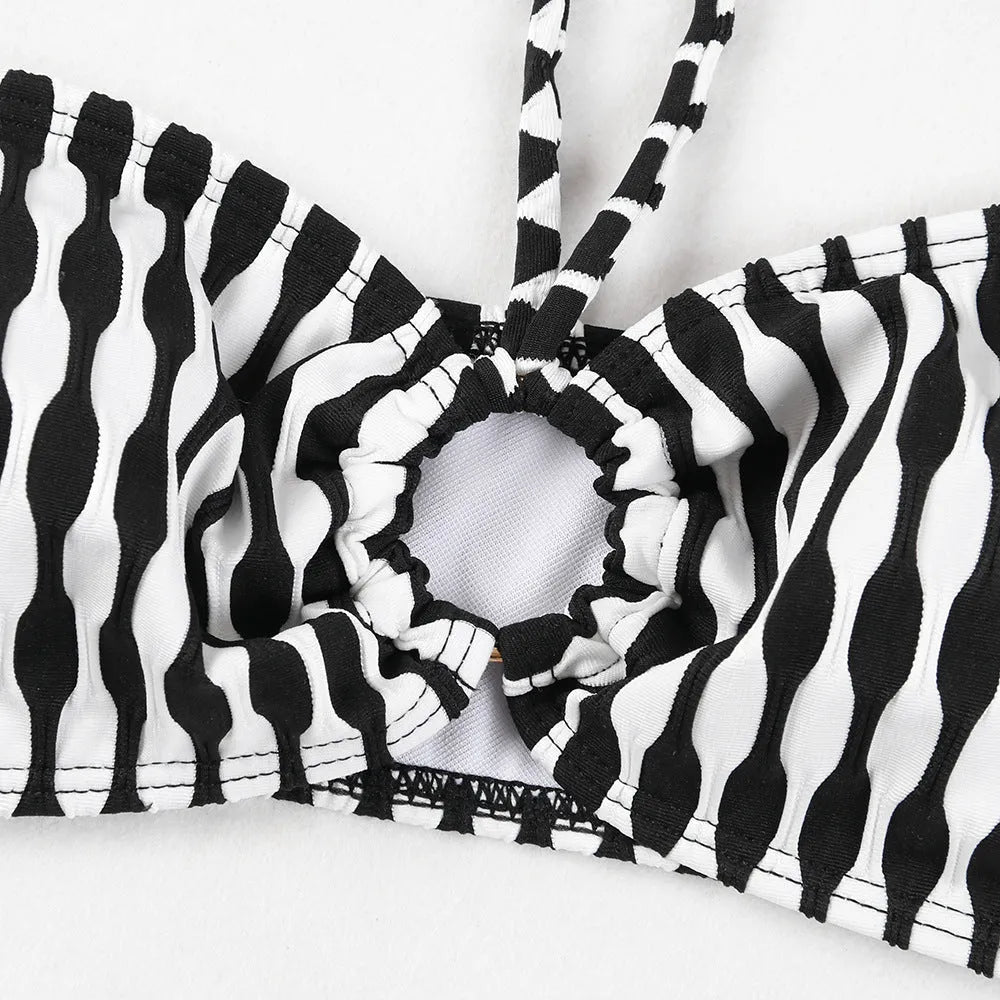 Women's striped three-piece swimsuit set with tube top, shorts, and waist skirt hem