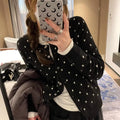 Women's gray dot pattern knitted cardigan with long sleeves and crocheted flower details