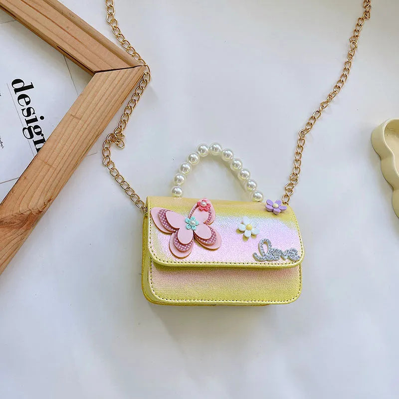Children's small PU leather shoulder bag with letter print in rose red, showing zipper closure and multiple internal slots