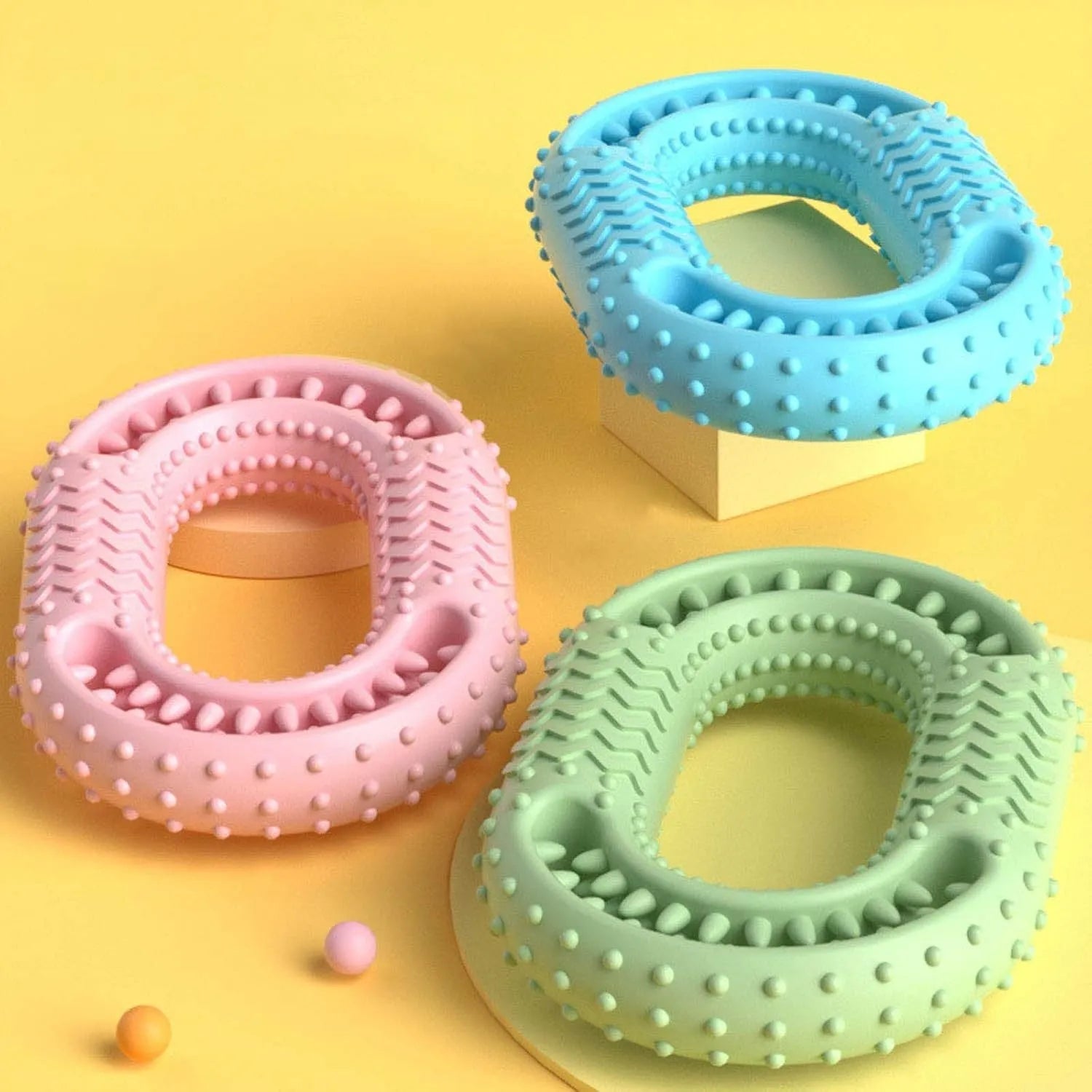 Blue O-ring shaped dog chew toy for aggressive chewers and dental health on a plain background.