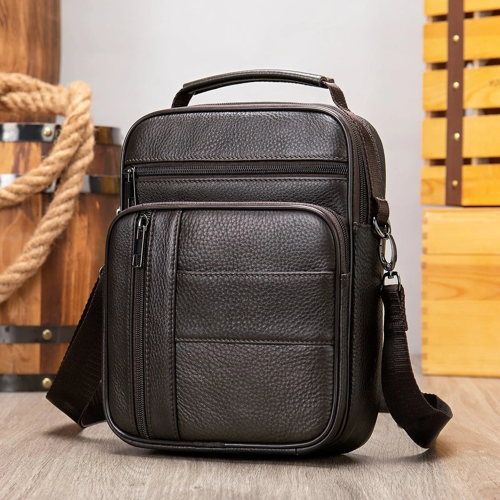 Men's black genuine leather vintage shoulder bag showing zipper opening and soft handle.