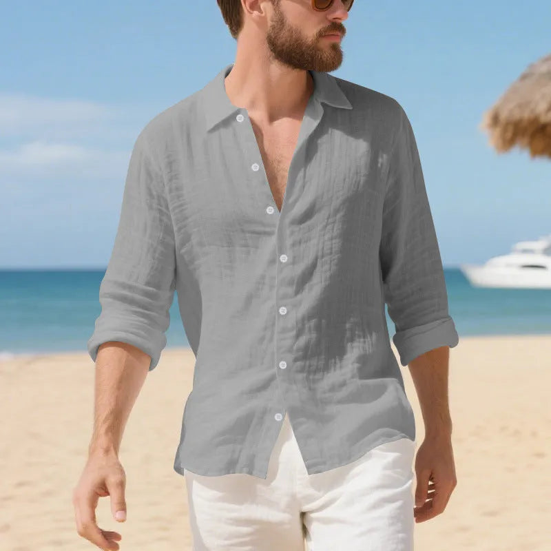 Men's loose fit linen Hawaiian casual shirt on a hanger, shown in light blue colour.