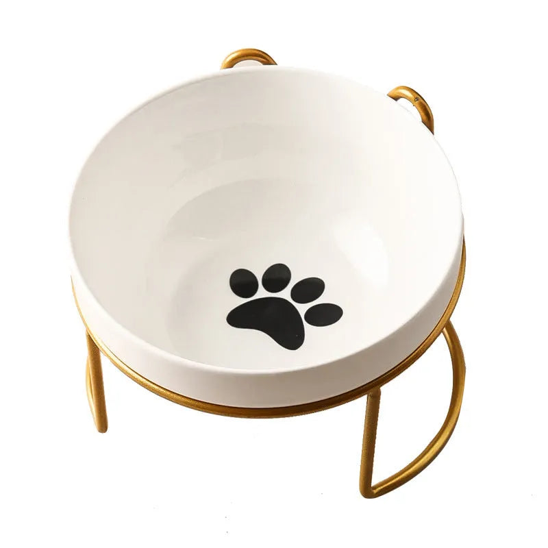 White ceramic cat bowl with cat paw print design on a black iron frame stand