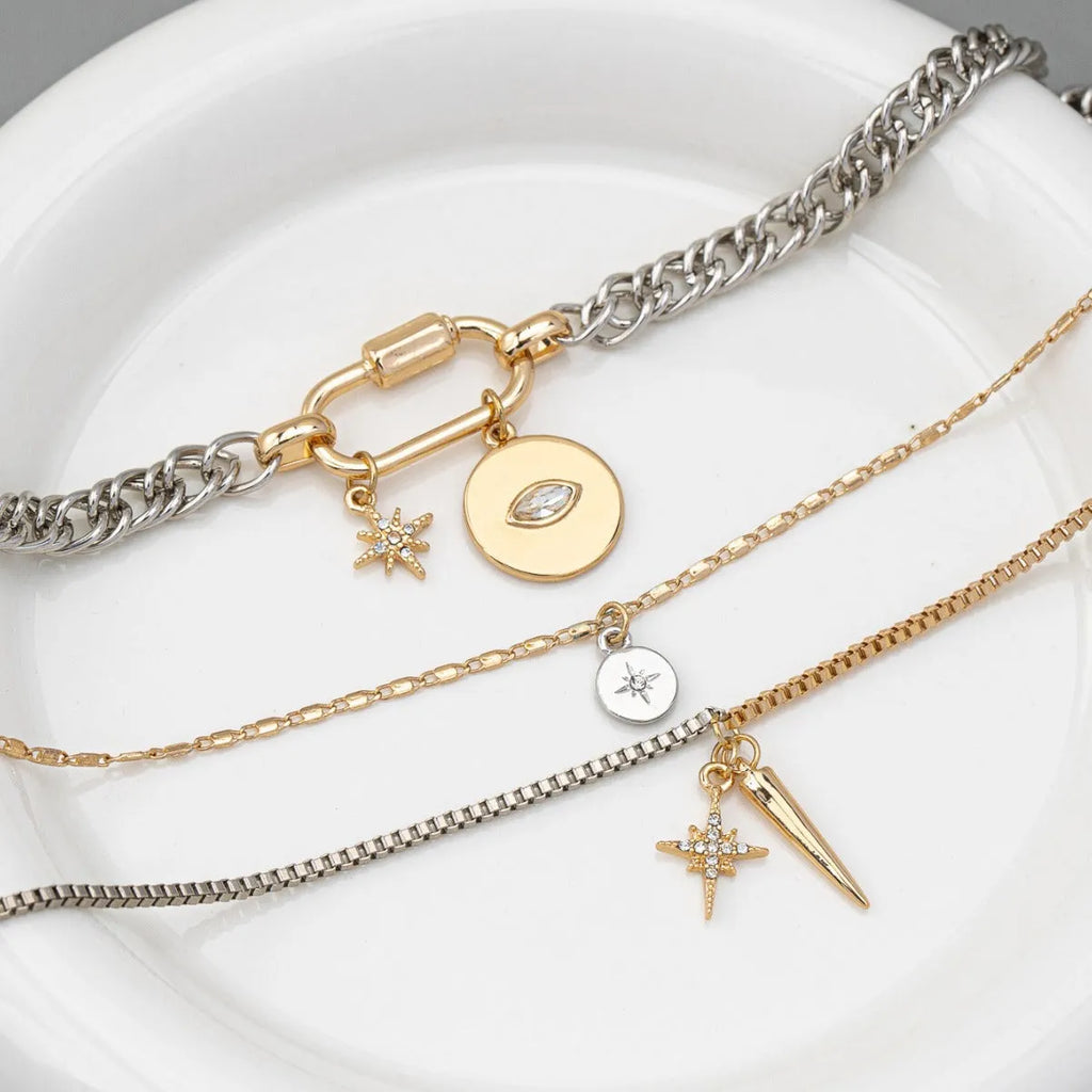 Alloy multi-layer twin necklace with geometric elliptical pendant on a white background