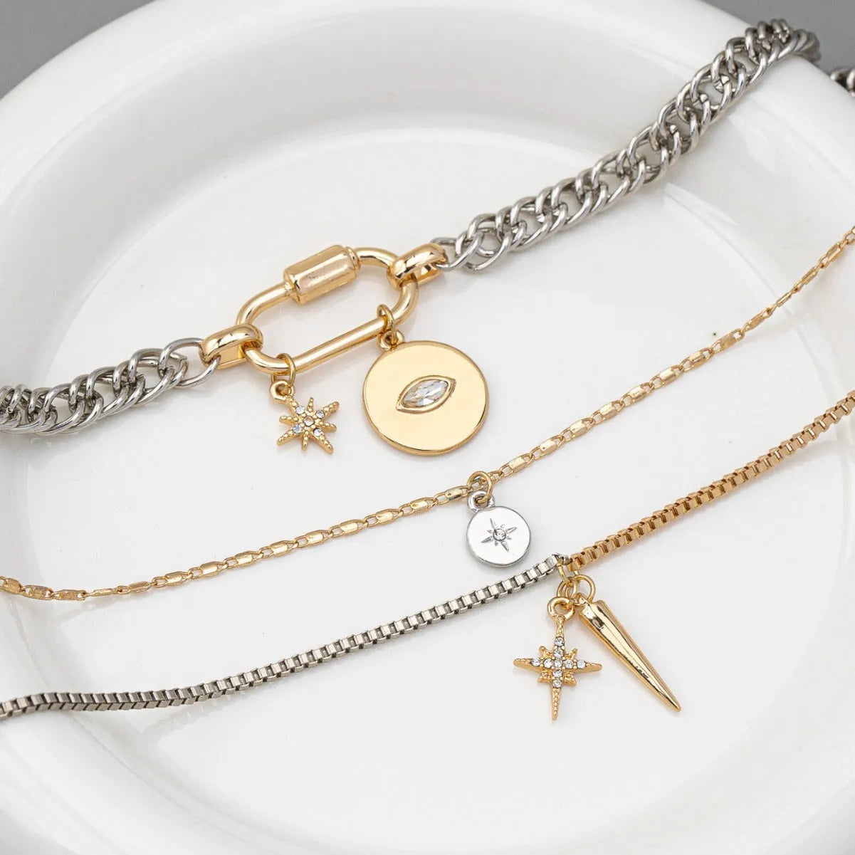 Alloy multi-layer twin necklace with geometric elliptical pendant on a white background
