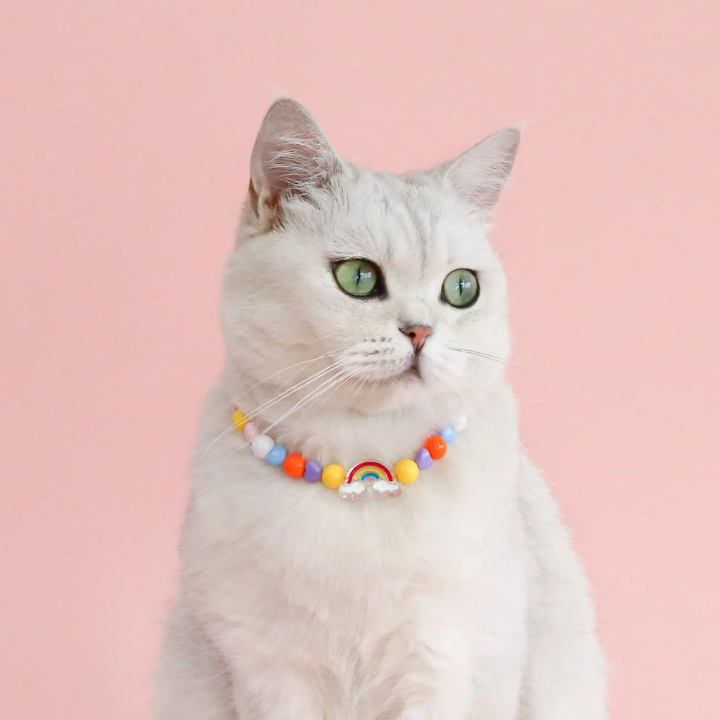 Colourful plastic bead cat necklace in small flower, rainbow, or peach design on adjustable cord.