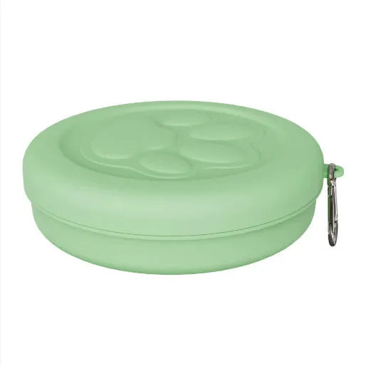Portable plastic dog bowl with snack compartment and metal carrying clip in light green colour.