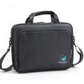 Black 15 inch nylon computer bag with shoulder strap on a flat surface