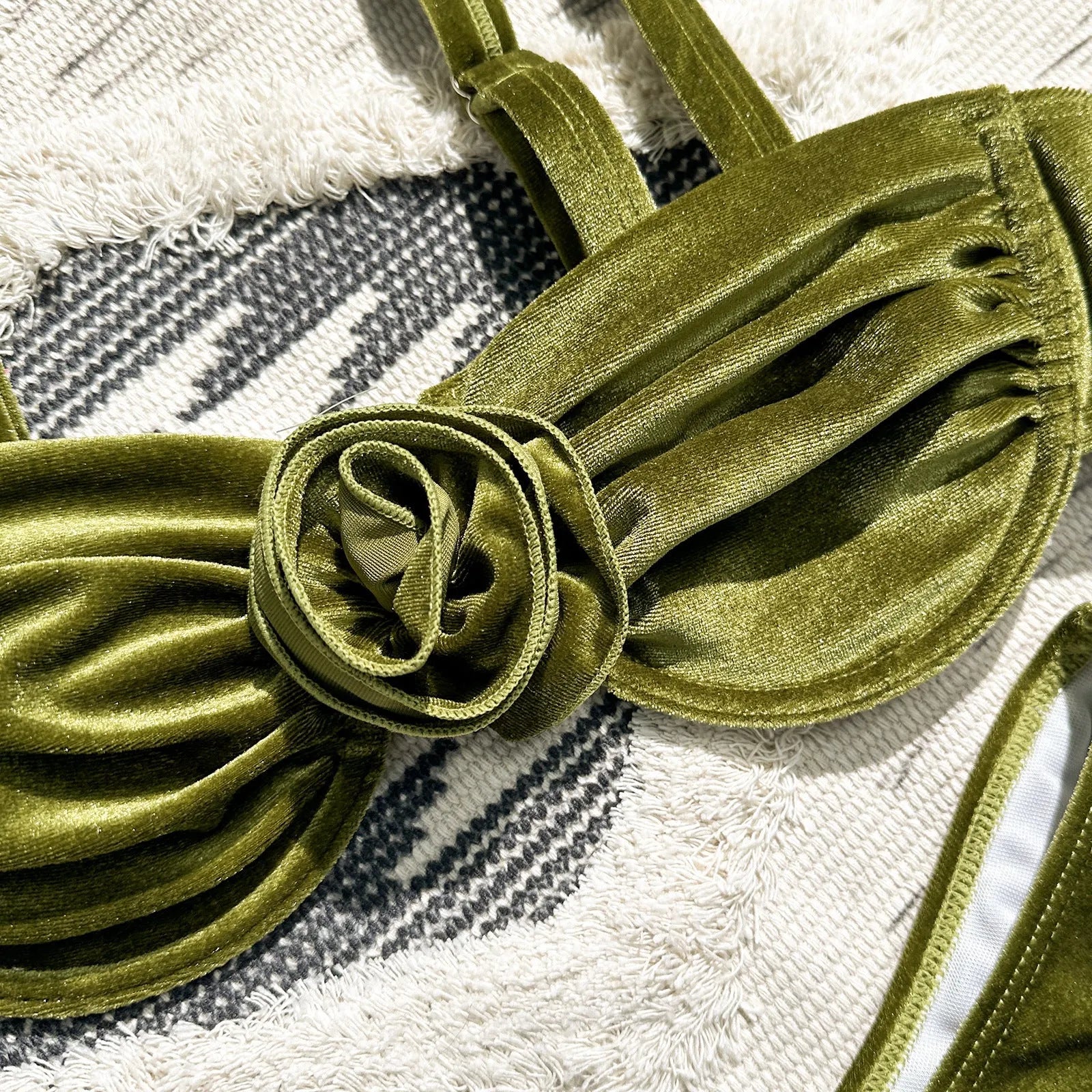 Women's 3D floral swimsuit briefs in green with matching bra, laid flat.