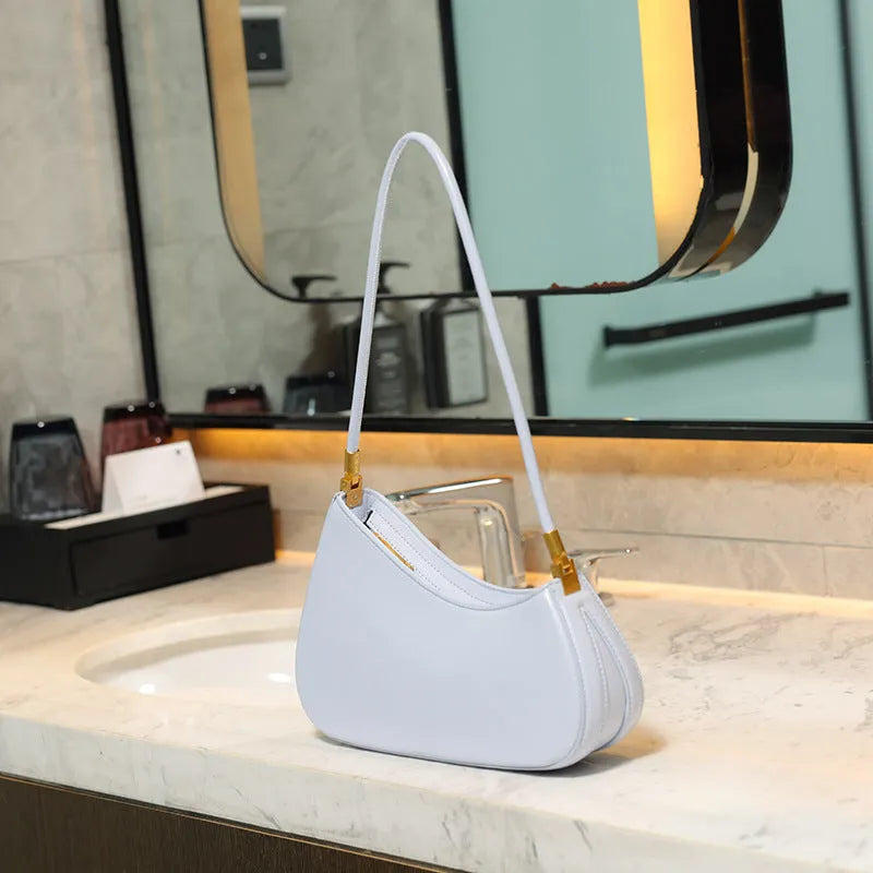 Women's retro oval underarm bag in PU with single strap and internal zip compartment, shown in multiple colour options