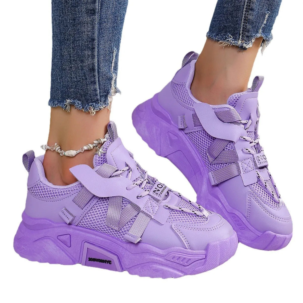 Women's platform mesh dad sports trainer in animal pattern, showing lace-up front and height-increasing sole.