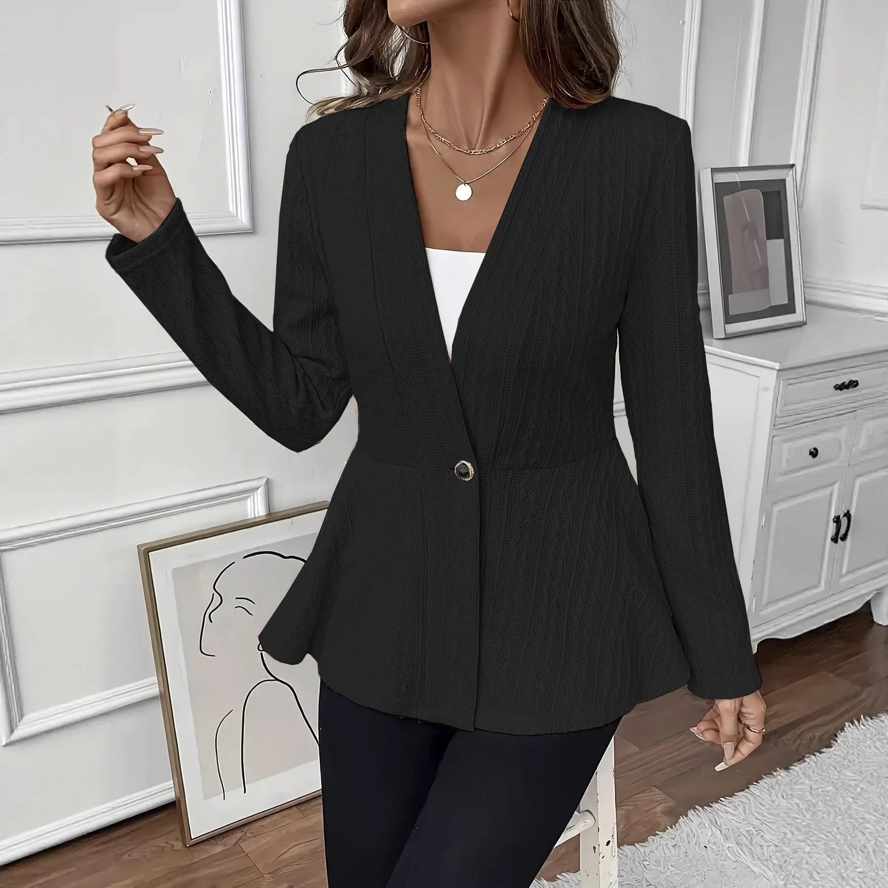 Women's apricot Jacquard knitted cardigan with a single button and long sleeves, laid flat.