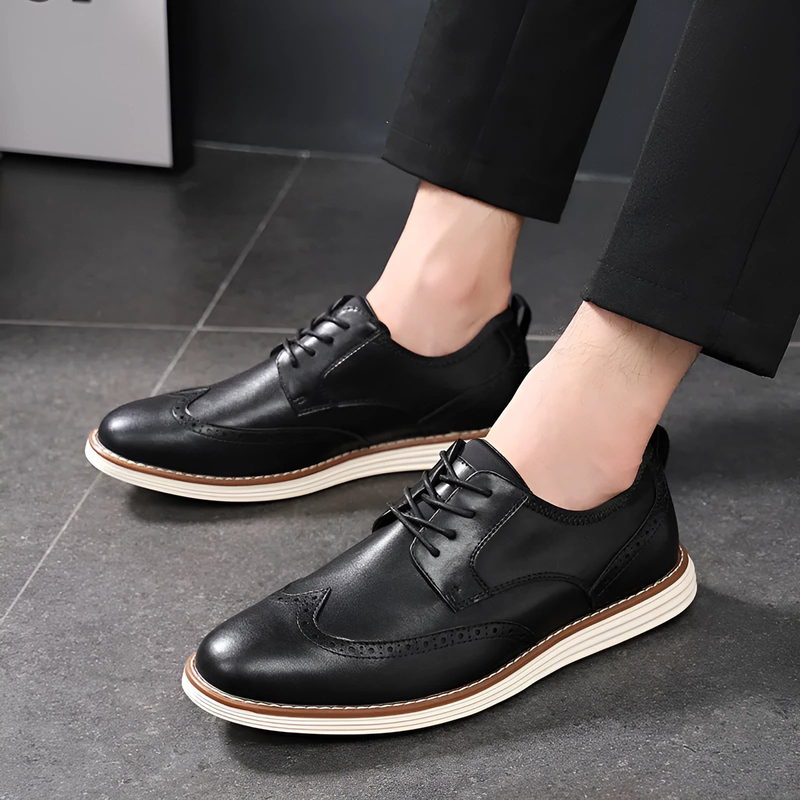 Men's black slip-on business casual shoe with round toe and carved PU upper detail on a white background.