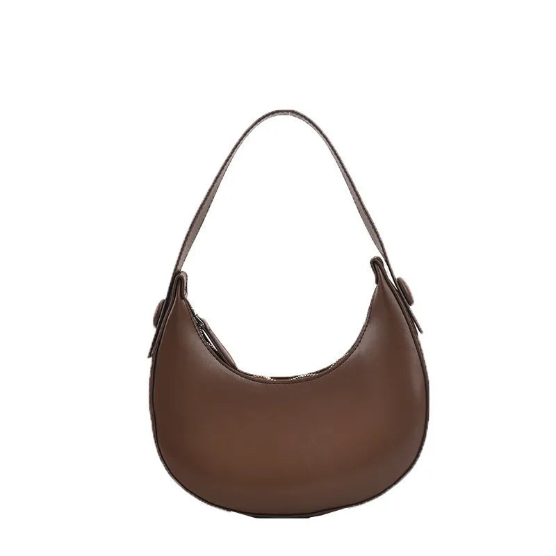 Women's retro dumpling-shaped PU leather shoulder bag in black showing sandwich pockets and zippered compartment