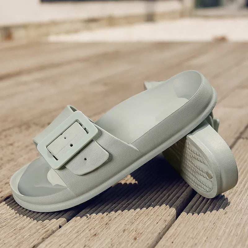 Women's grey blue EVA buckle slippers showing buckle detail and textured sole