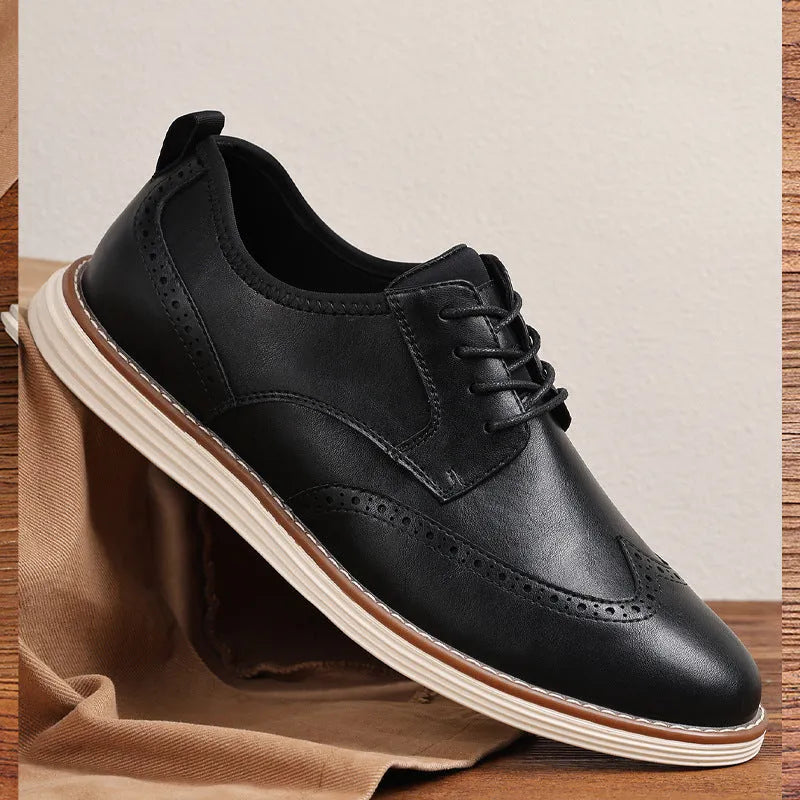 Men's black slip-on business casual shoe with round toe and carved PU upper detail on a white background.