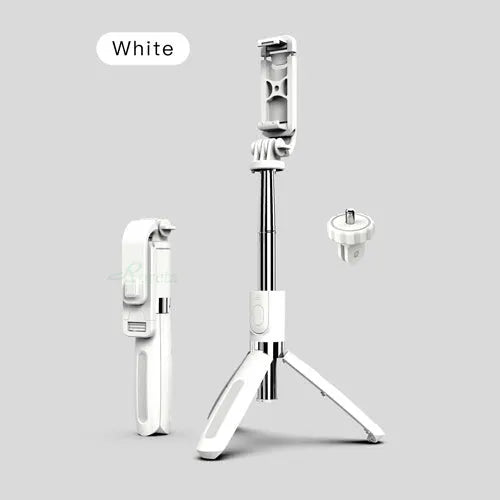 Extended black Bluetooth selfie stick with phone attached and separate wireless remote on a table