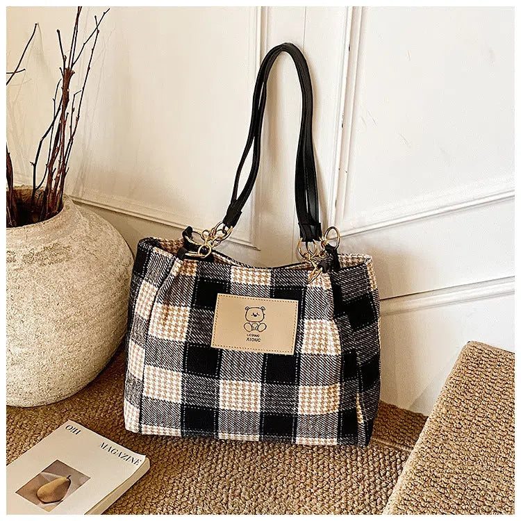 Wool plaid women's single-shoulder commuter bag in brown with stitched seam detailing and double straps