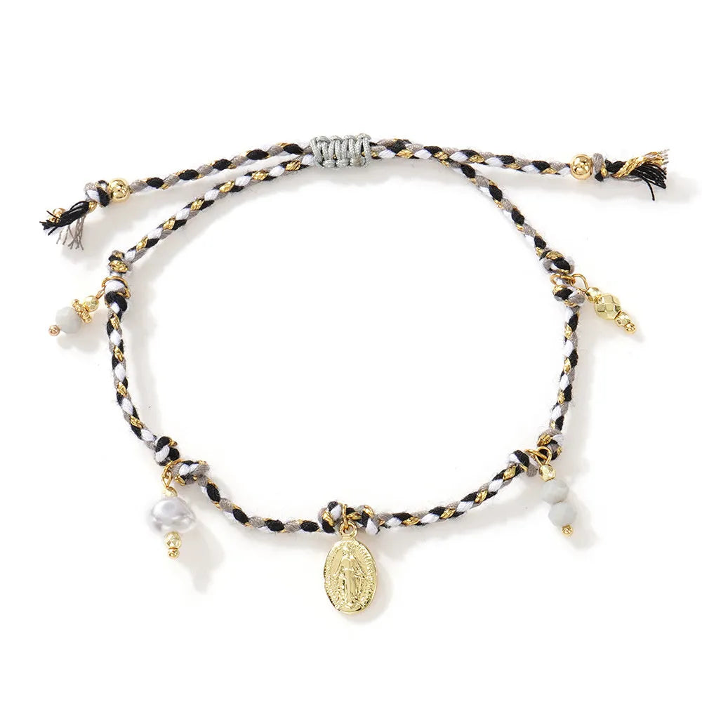 Hand-woven women's bracelet made from colourful braided rope with an integrated carrying strap tag design.