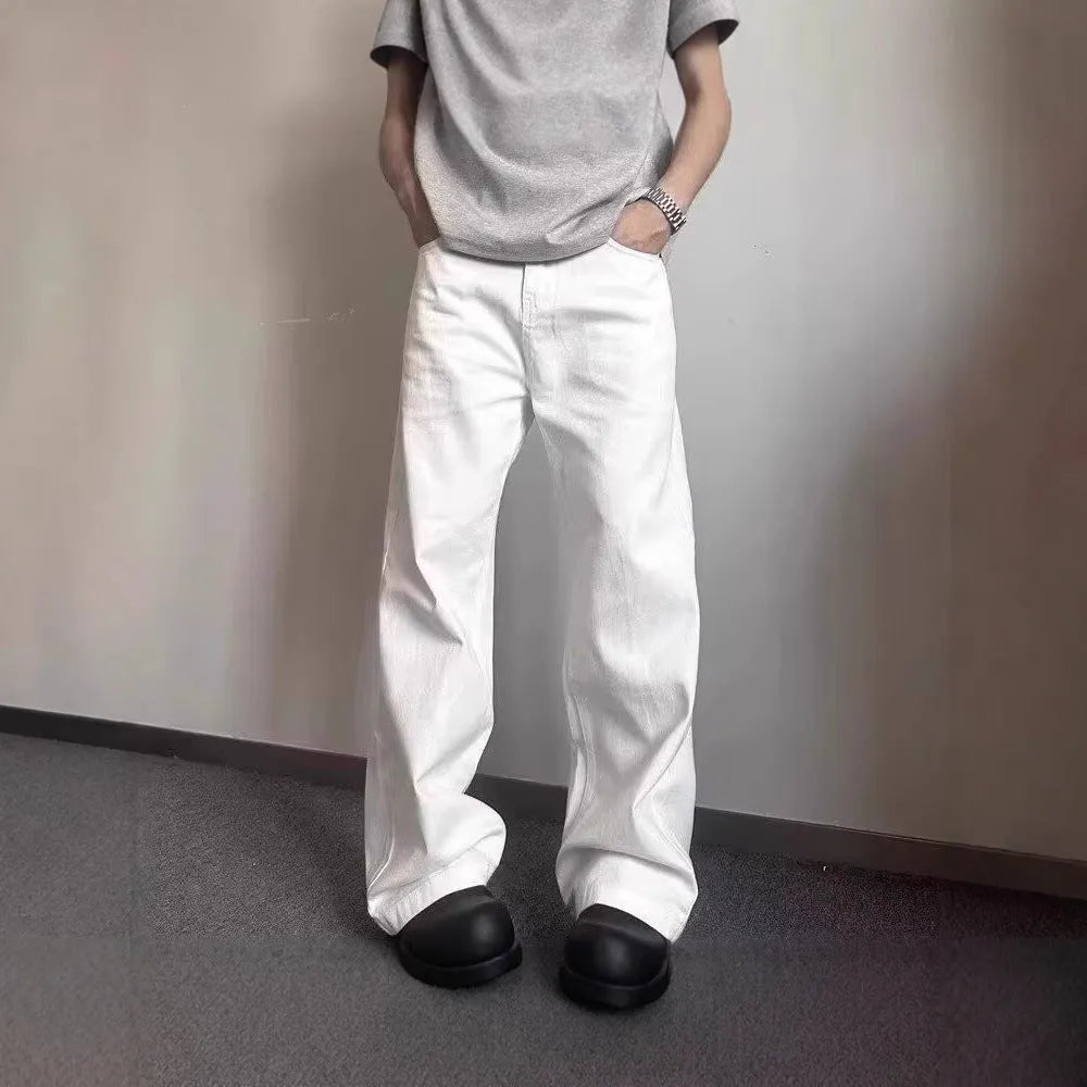 Men's white straight-leg denim jeans with a mid waist and zipper fly on a neutral background.