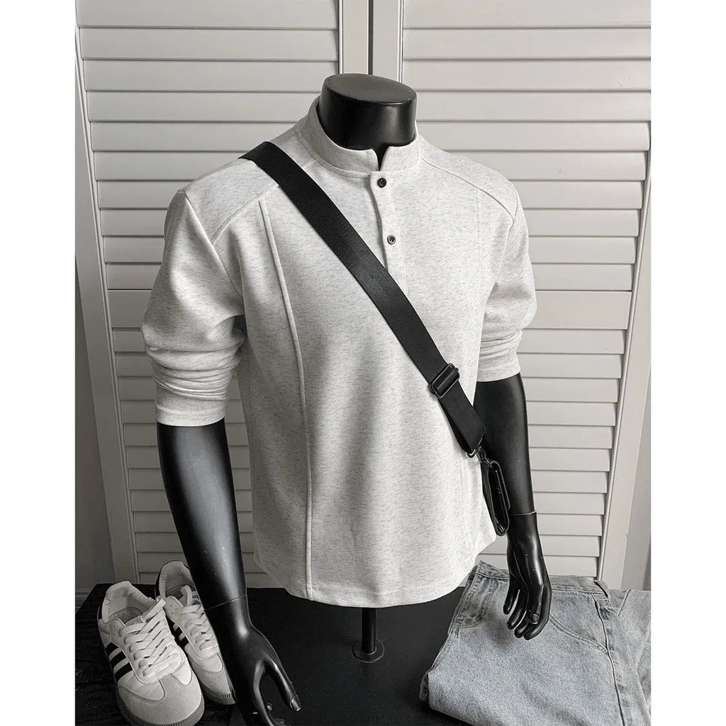 Men's grey asymmetrical stand-up collar cotton polo shirt with patchwork shoulder detail.