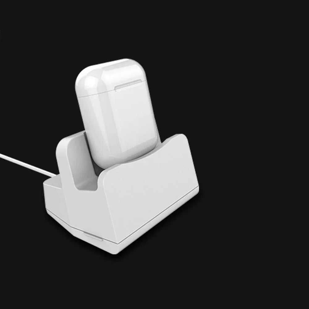 White headphone charging base stand on a desktop holding a gaming headset